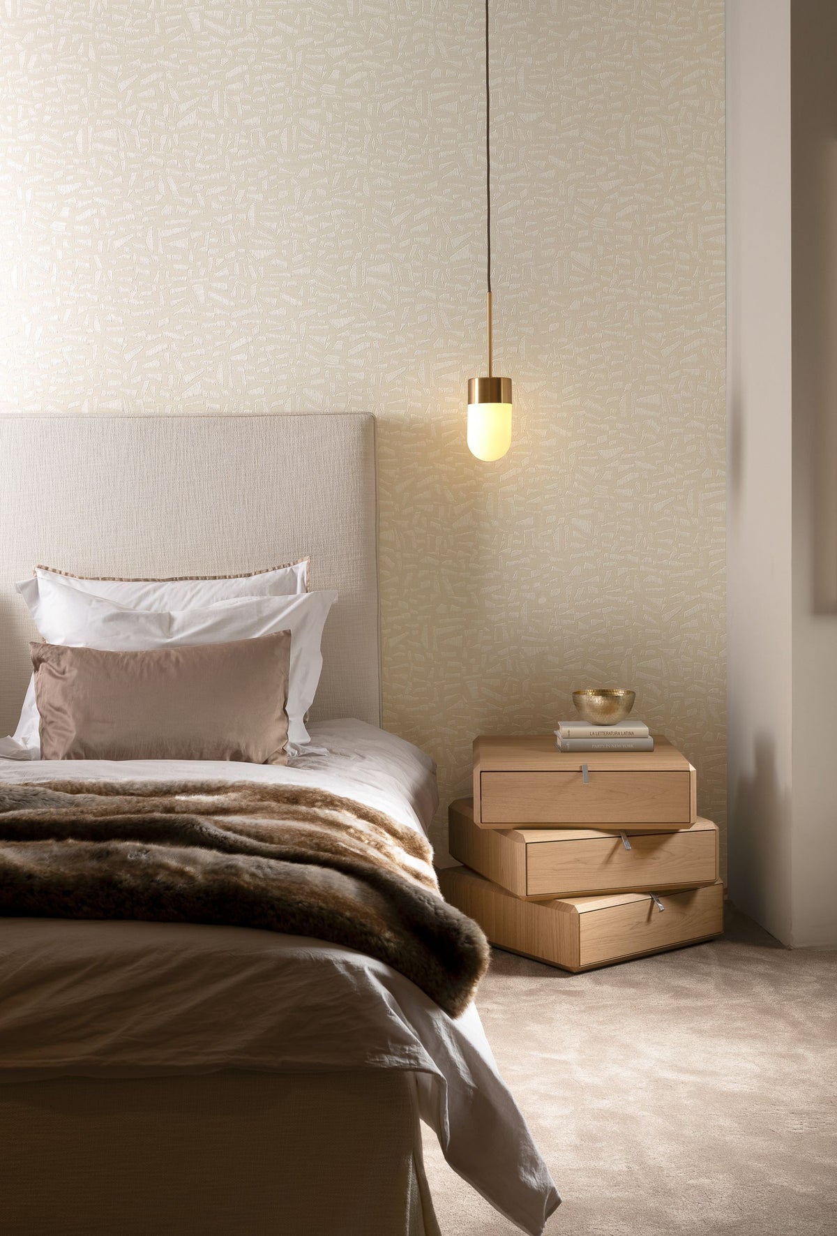 Kona wallpaper by Arte in Cream in a bedroom with a pendant light