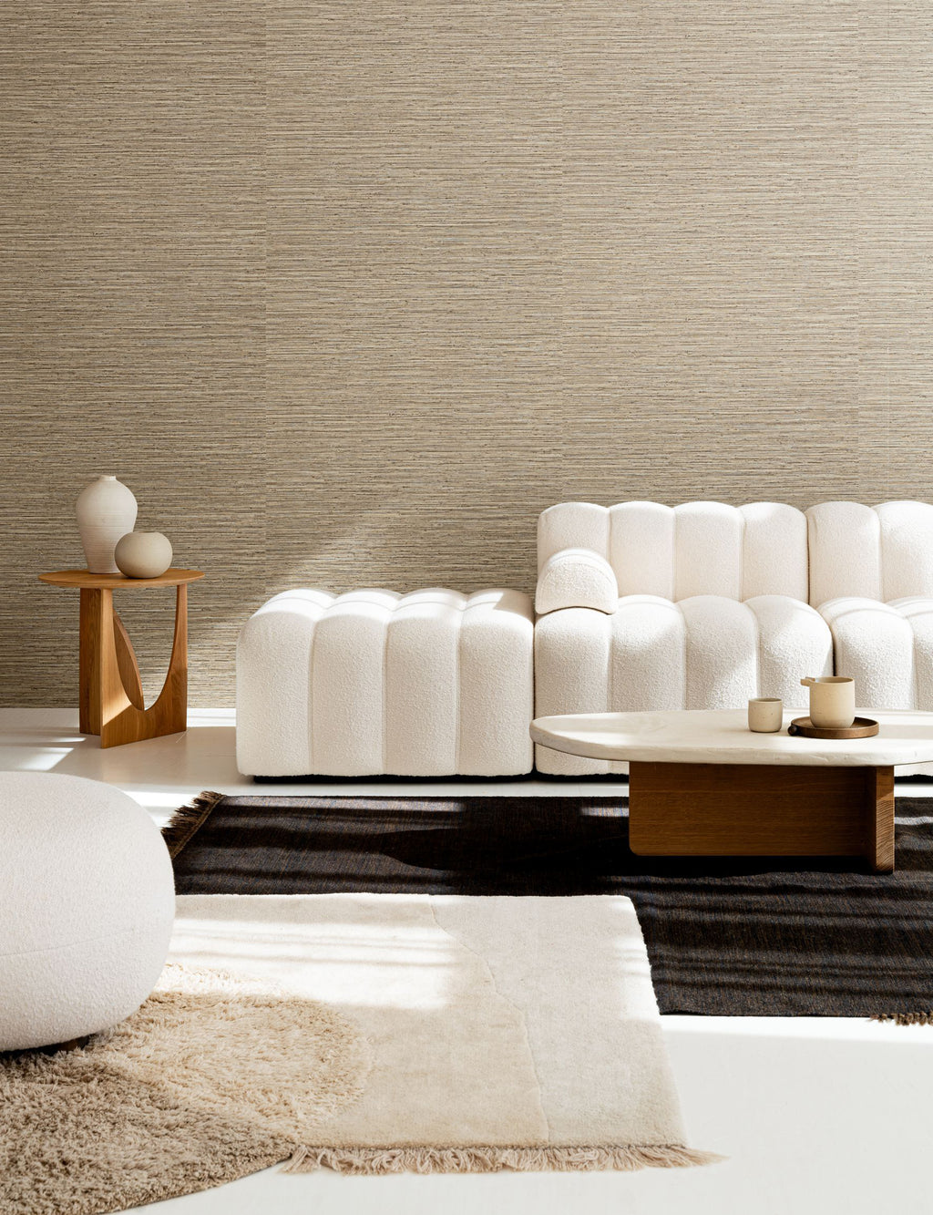 Matiz wallpaper by Arte in Beige – Hazel behind a white sofa and a round side table