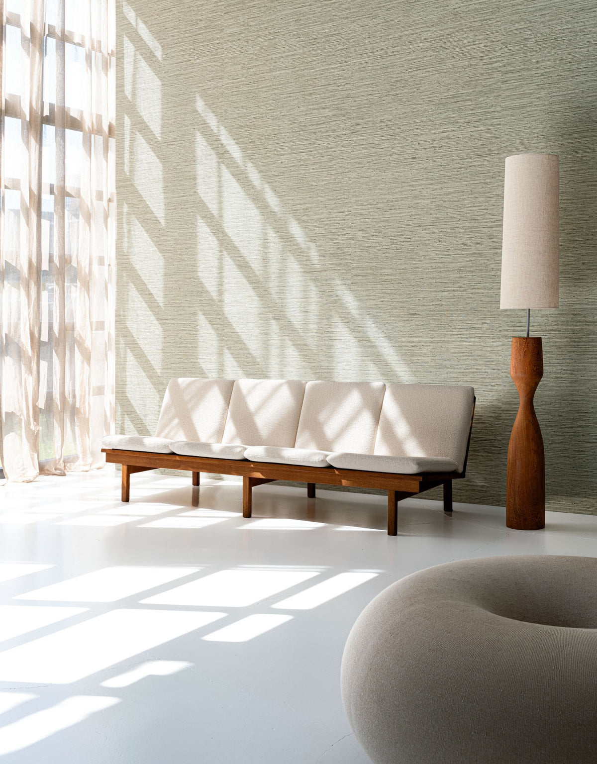 Matiz wallpaper by Arte in Beige – Elephant in a bright room with a sofa and a tall floor lamp