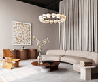 Ovillo wallpaper by Arte in Beige – Mink in a living room with a curved sofa and a chandelier