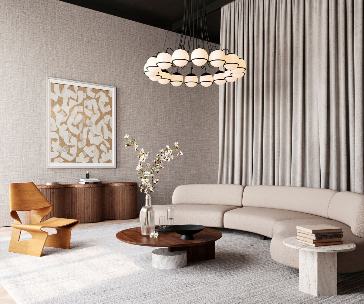 Ovillo wallpaper by Arte in Beige – Mink in a living room with a curved sofa and a chandelier