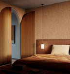 Puna wallpaper by Arte in Brown in a bedroom with timber joinery