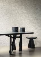 Ritorto wallpaper by Arte in Beige – Shadow behind a black table and stool