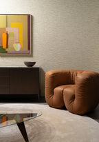 Ritorto wallpaper by Arte in Beige – Latte behind a tan leather armchair and a painting