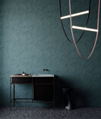 Shards wallpaper by Arte in Teal behind a black console and a sculptural pendant light