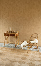 Tamba wallpaper by Arte in Orange behind a cane desk and a rattan chair