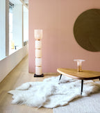 Alma by Arte wallpaper by Arte in Pink in a hallway with a floor lamp and a low timber table