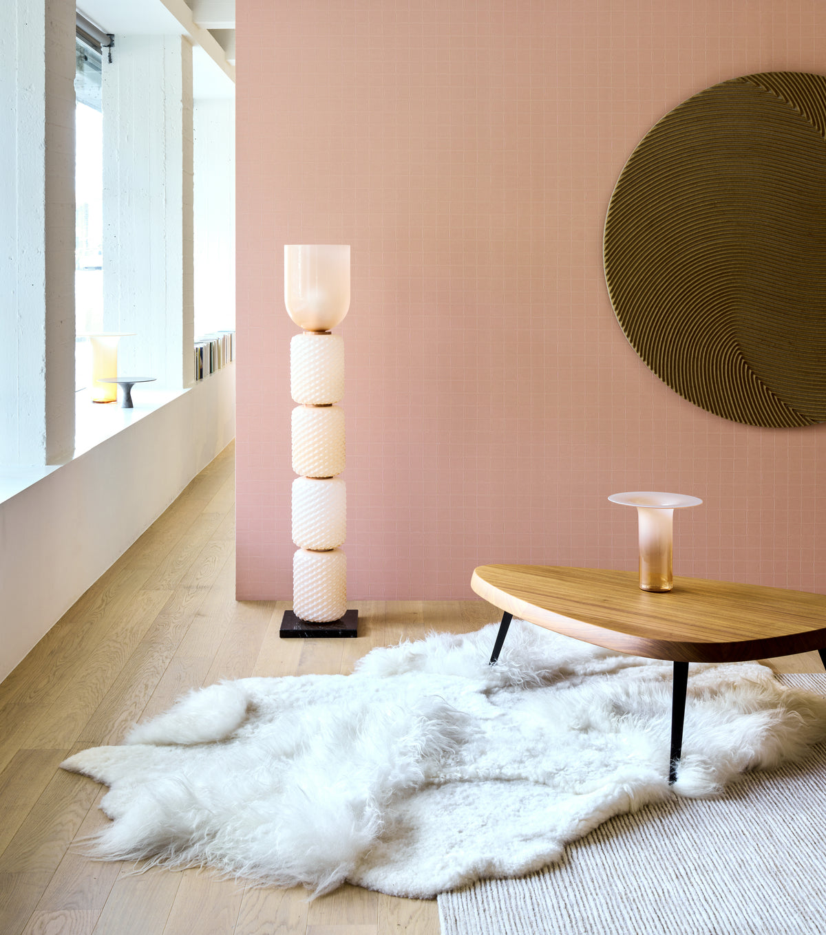 Alma by Arte wallpaper by Arte in Pink in a hallway with a floor lamp and a low timber table