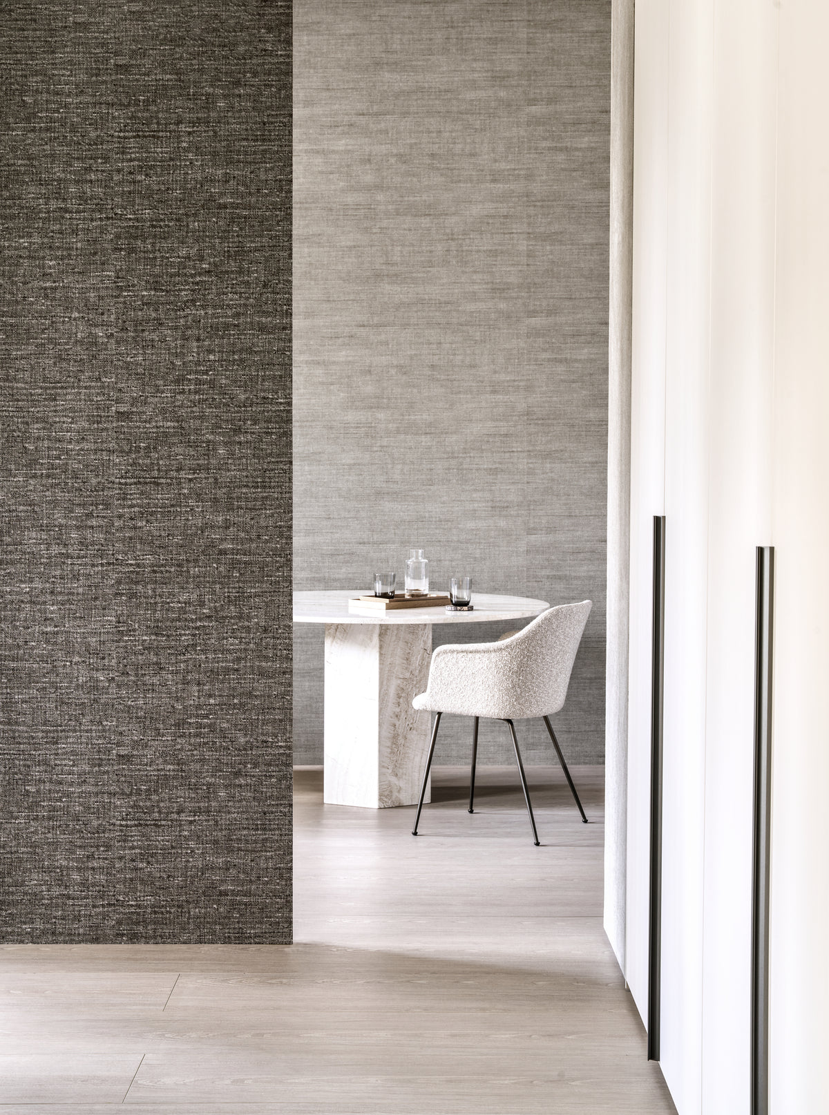 Aspero wallpaper by Arte in Brown – Fjord in a doorway beside a round dining table