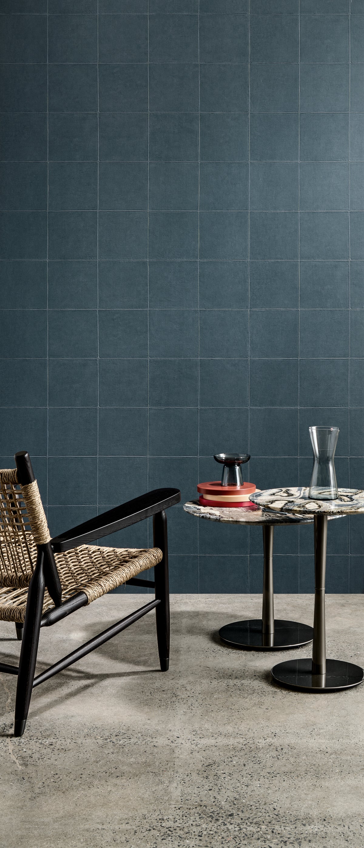 Campo wallpaper by Arte in Blue behind a cane chair and a small round table