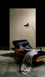 Campo wallpaper by Arte in Beige – Clay behind a leather lounger and a floor lamp