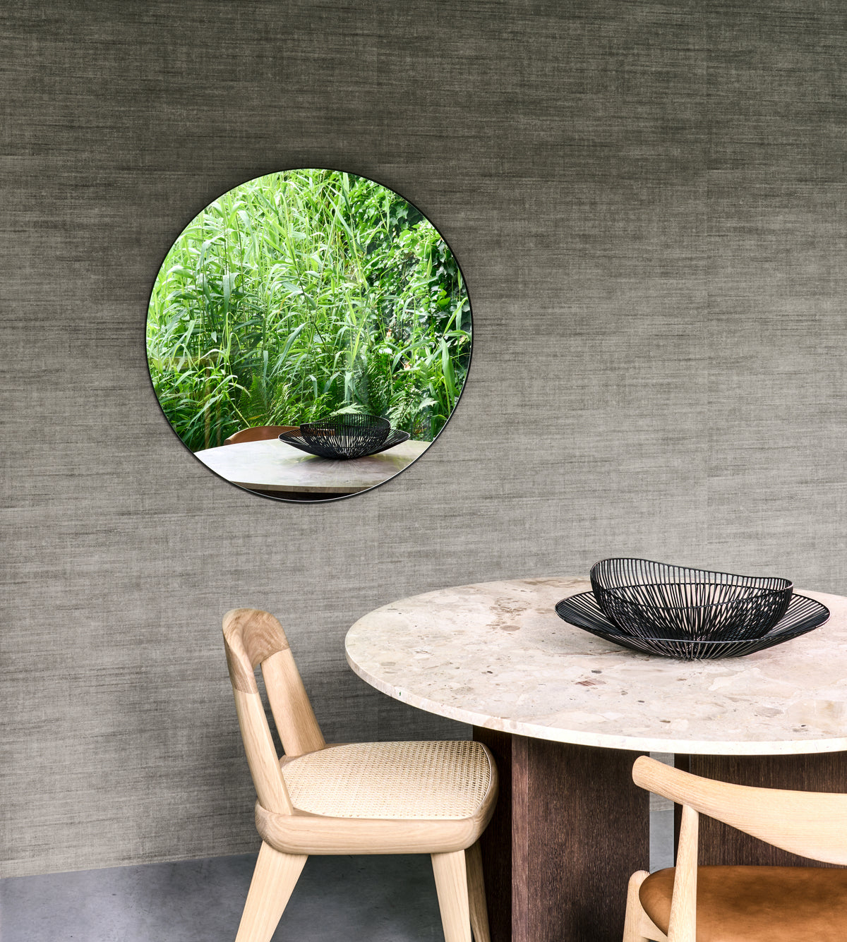 Canvas wallpaper by Arte in Grey – Urban behind a round dining table with a circular mirror