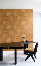 Cuadro wallpaper by Arte in Orange behind a black desk and a timber chair