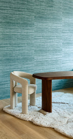 Tasar wallpaper by Arte in Teal – Teal behind a dining table and cream chairs