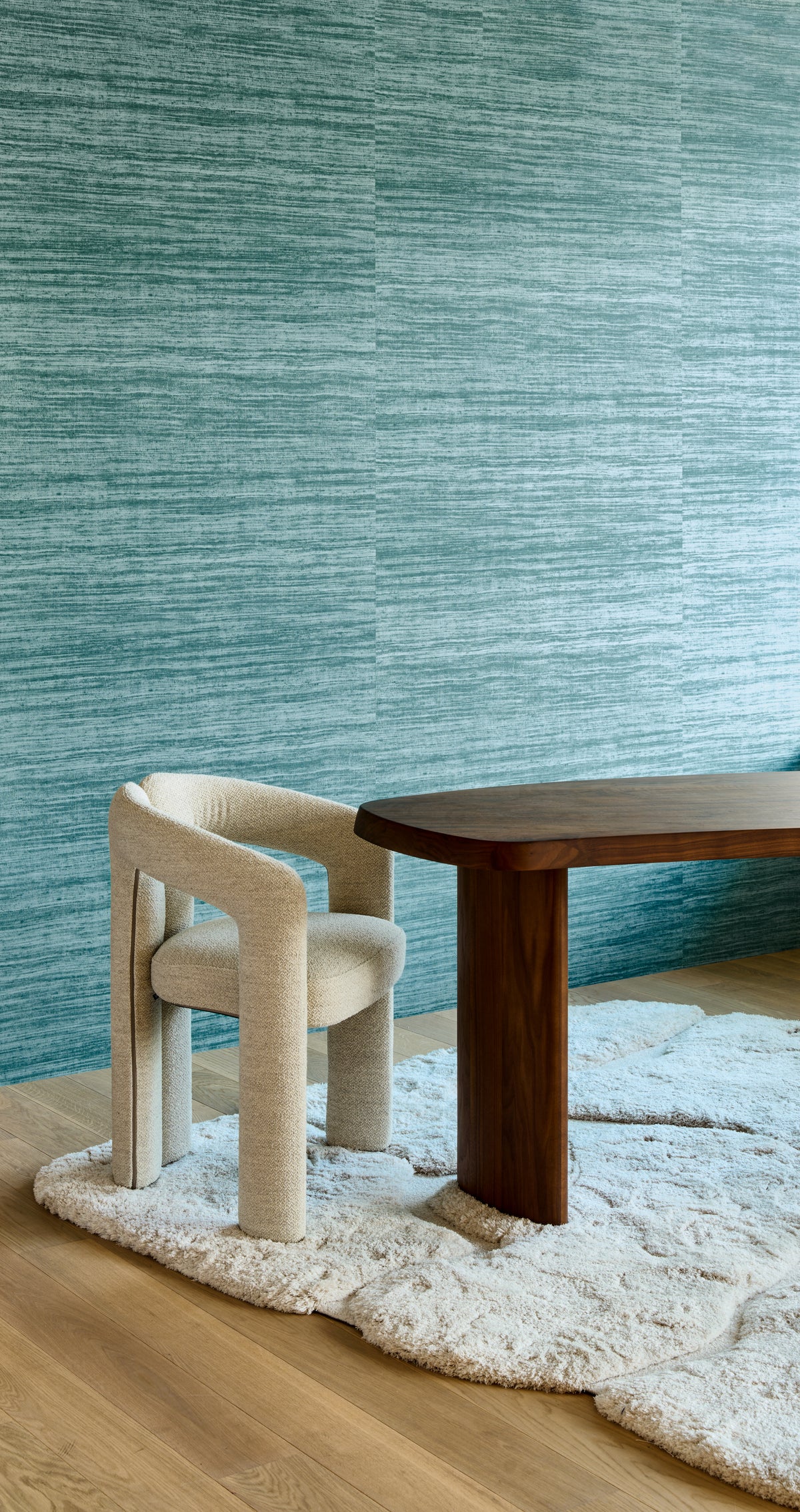 Tasar wallpaper by Arte in Teal – Teal behind a dining table and cream chairs