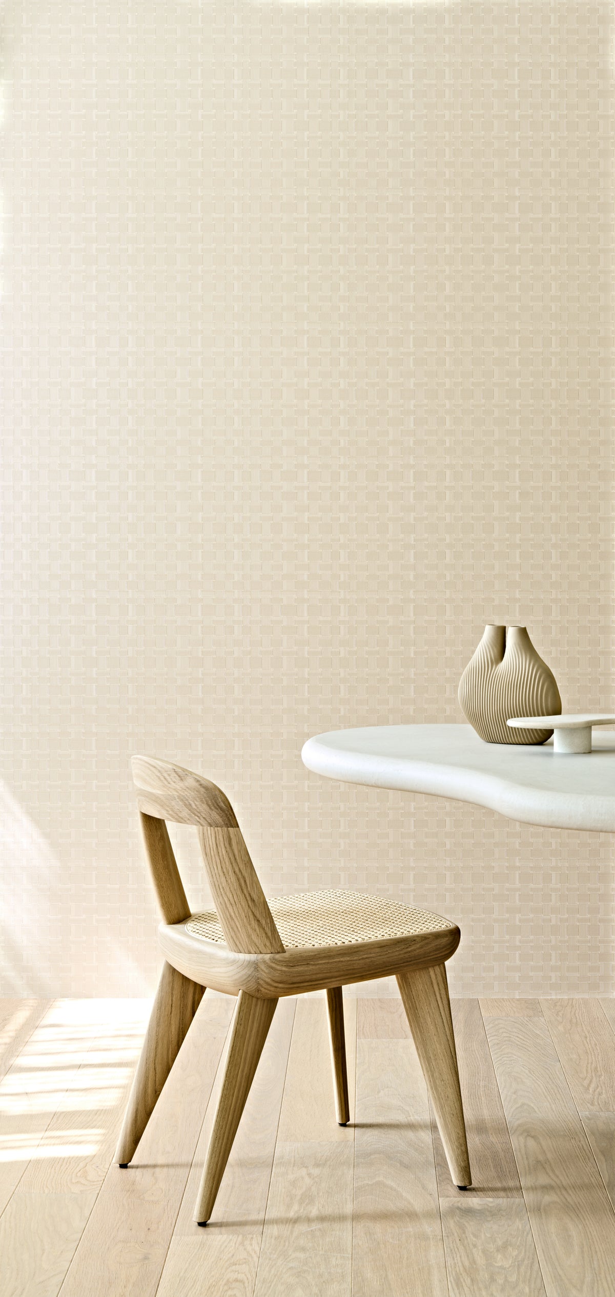 Weave wallpaper by Arte in Cream behind a timber chair and a small round table