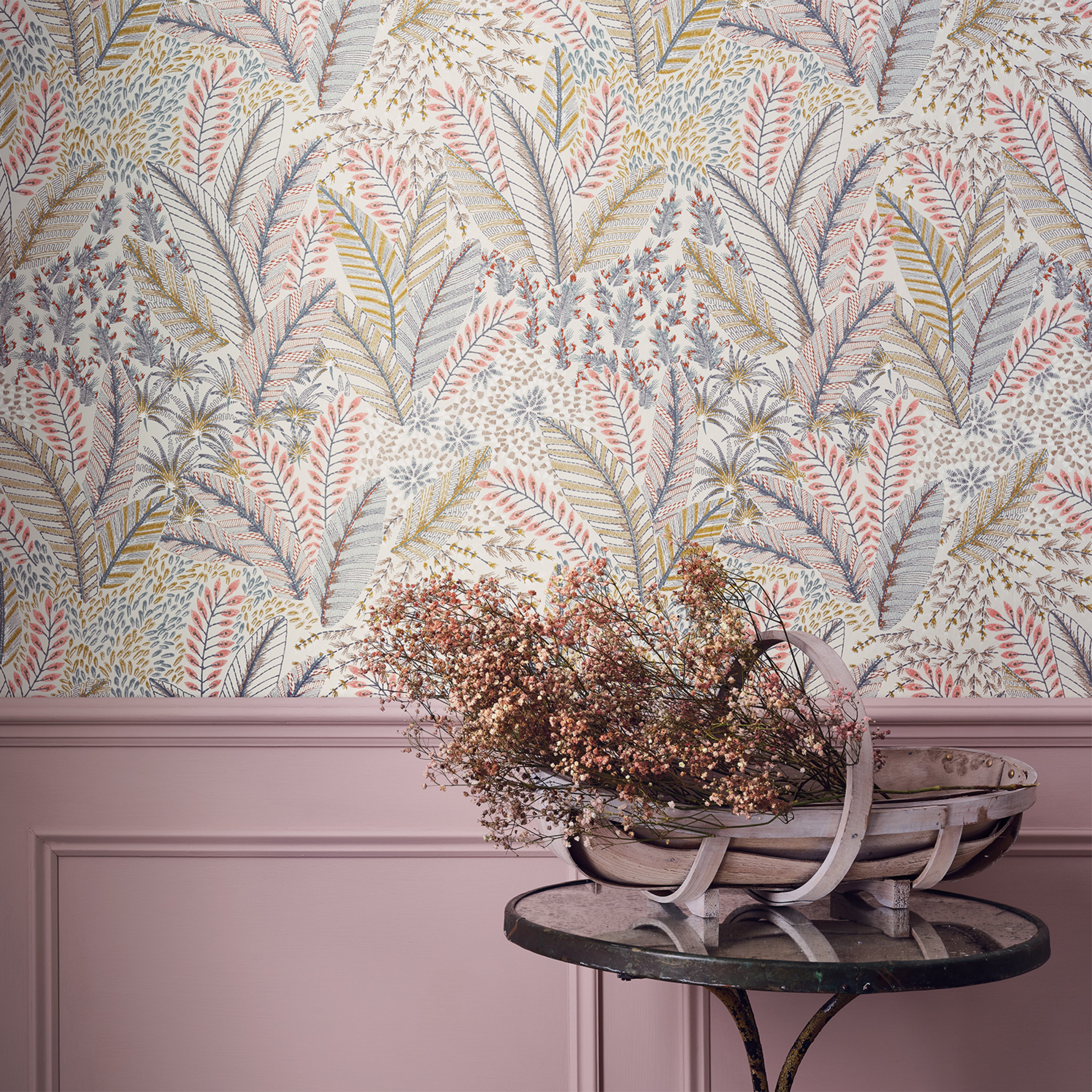 Chiraco wallpaper by Romo in Sorbet - tropical design, pastel fronds above pink panelling with a black side table