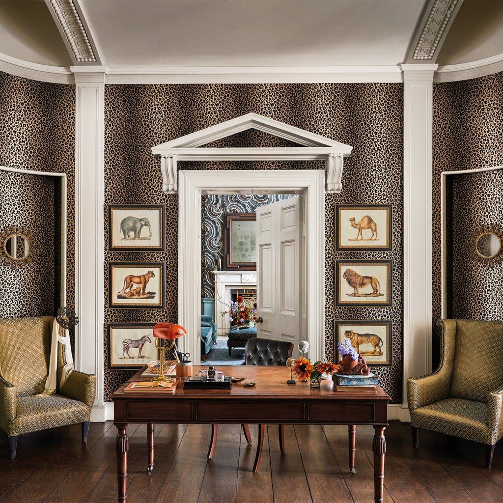 Mimi Leopard wallpaper by Romo in Tan - animals design, leopard spots in a study with framed prints and a writing desk