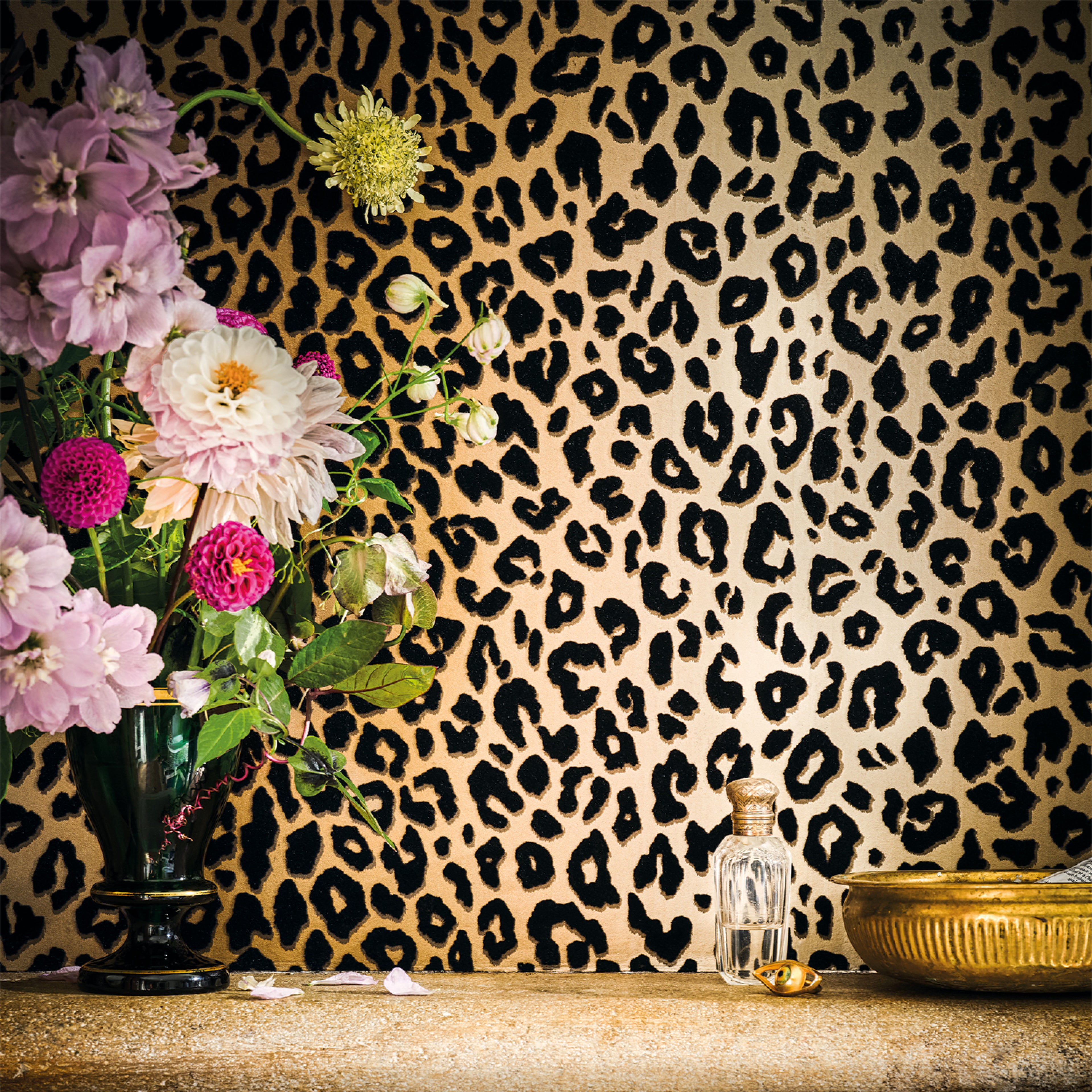 Mimi Leopard wallpaper by Romo in Tan - animals design, leopard spots behind a dahlia arrangement and a gold bowl