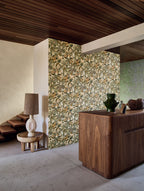 Tehuana wallpaper by Casamance in celadon and almond, a botanical floral print styled on a partition wall beneath a slatted timber ceiling