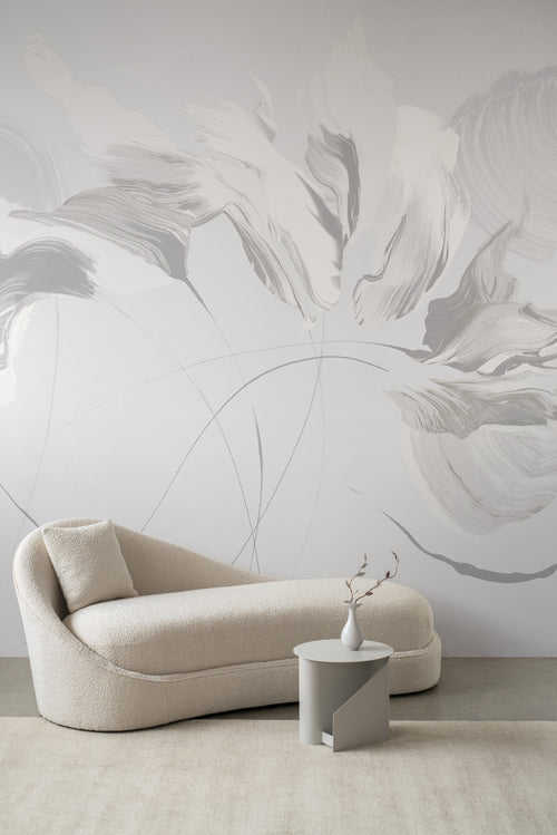 Aurora wallpaper by Emma Hayes in pearl, large soft brushstroke floral in pale grey behind a boucle chaise