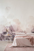 Bloom wallpaper by Emma Hayes in plum, watercolour petals rising up a wall above a blush-toned bed