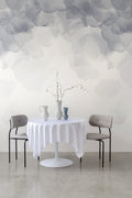 Bloom wallpaper by Emma Hayes in smoke grey, watercolour petals over a white dining table with vases