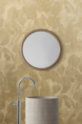 Botanic wallpaper by Emma Hayes in gold, tonal mustard watercolour leaves behind a bathroom basin