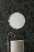 Botanic wallpaper by Emma Hayes in moss, dark green watercolour leaves behind a basin and round mirror