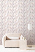 Colour Field wallpaper by Emma Hayes in Mauve, blush pink and lilac speckled watercolour texture in a living room with a boucle sofa