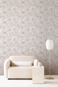 Colour Field wallpaper by Emma Hayes in Taupe, neutral beige and grey mottled watercolour texture behind a cream boucle sofa and lamp