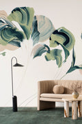 Daybreak wall mural by Emma Hayes in Verde, bold green and navy painterly abstract florals on a cream ground styled above a tan boucle sofa