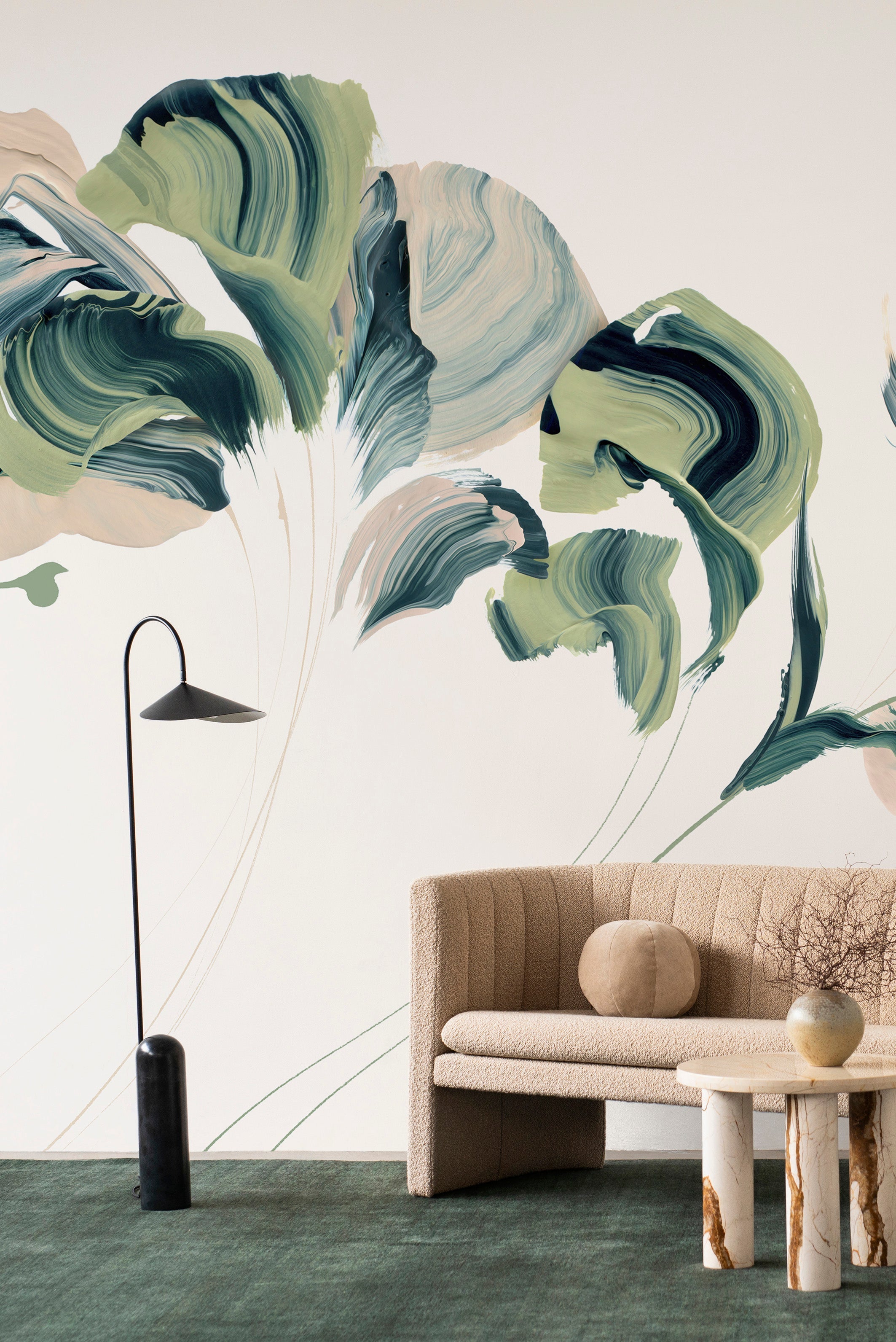 Daybreak wall mural by Emma Hayes in Verde, bold green and navy painterly abstract florals on a cream ground styled above a tan boucle sofa