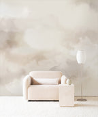 Dispersion wall mural by Emma Hayes in Air, soft cream and pale beige watercolour clouds behind a boucle armchair