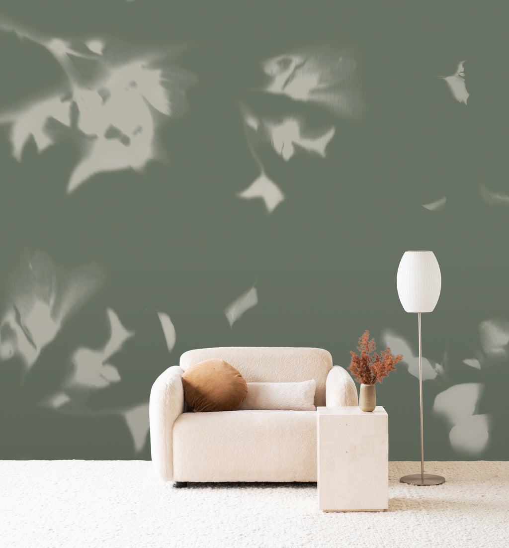 Drift wall mural by Emma Hayes in Sage, pale leaf silhouettes drifting across a muted sage-green wall