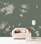 Drift wall mural by Emma Hayes in Sage, pale leaf silhouettes drifting across a muted sage-green wall