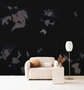 Drift wall mural by Emma Hayes in Shadow, grey botanical silhouettes on a deep ink-black ground