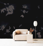 Drift wall mural by Emma Hayes in Shadow, grey botanical silhouettes on a deep ink-black ground