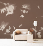 Drift wall mural by Emma Hayes in Umber, cream foliage shadows on a warm earthy brown wall