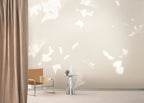 Drift wallpaper by Emma Hayes in Wheat, cyanotype foliage mural styled across a wide living-room wall — hero lifestyle shot