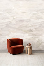 Dune wall mural by Emma Hayes in Buff, soft cream and pale beige watercolour dunes behind a rust velvet armchair