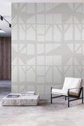 Geo-graphic wallpaper by Emma Hayes in soft silver-grey, subtle tonal abstract lattice styled in a minimal room with a stone
