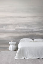 Sediment wall mural by Emma Hayes in Greystone, soft tonal grey watercolour bands styled in a serene bedroom with white linen and pale rug