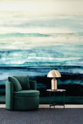 Sediment wall mural by Emma Hayes in Turquoise, aqua and teal watercolour layers over deep blue, styled with a green velvet