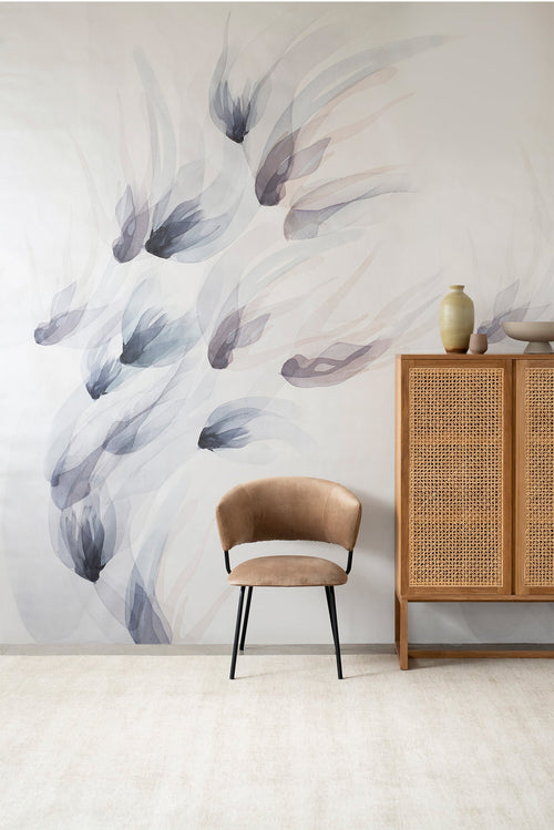 Songbird wall mural by Emma Hayes in Dusk, soft grey and mauve watercolour birds in flight styled above a tan velvet chair