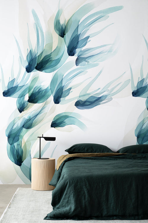 Songbird wall mural by Emma Hayes in Teal, flowing blue-green watercolour birds in flight styled in a bedroom behind a dark
