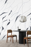 Vine wall mural by Emma Hayes in Charcoal, hand-drawn navy-charcoal leaves on white, styled in a dining room with a black