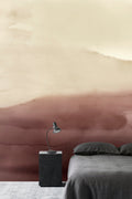 Wash wall mural by Emma Hayes in clay terracotta watercolour wash, styled in a bedroom with charcoal bedding and black bedside table