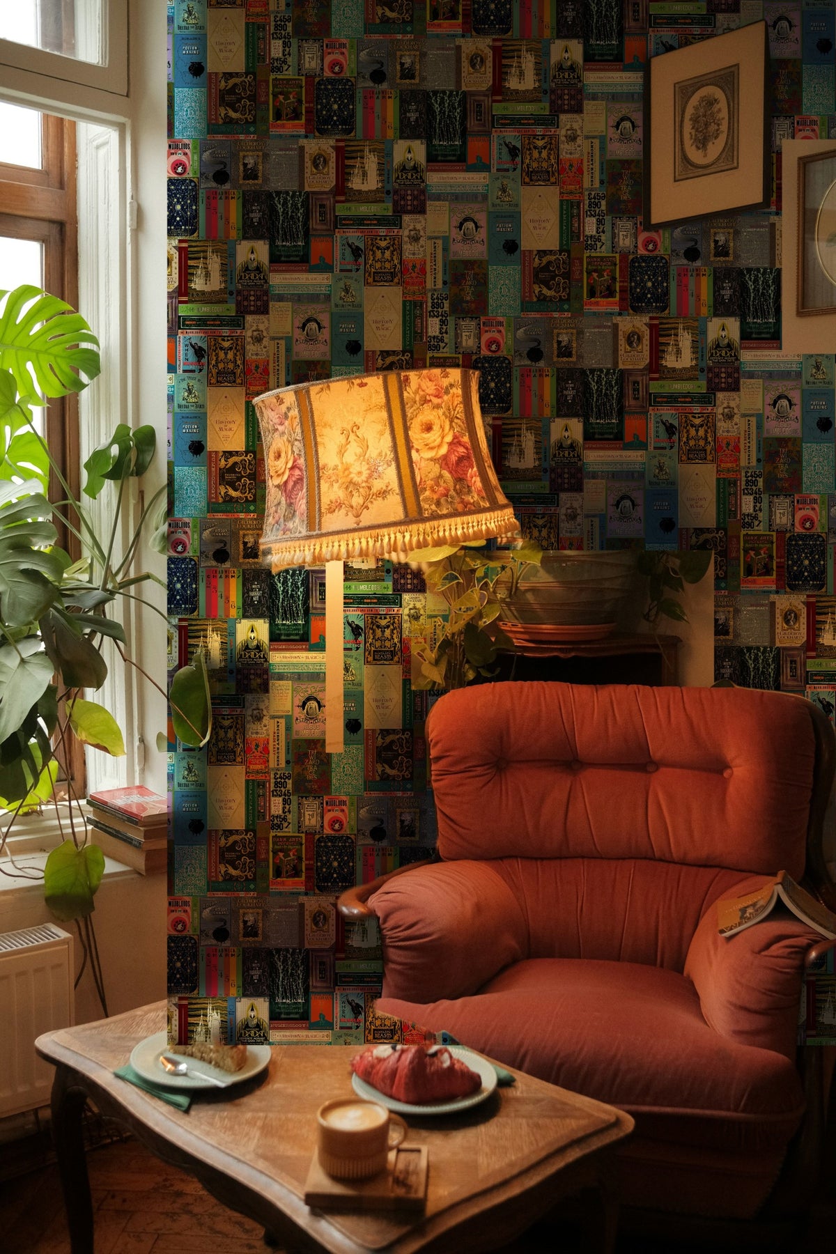 Harry Potter Hogwarts Library Bookshelf wallpaper mural on the wall of a reading nook with a pink velvet armchair
