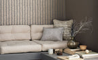 Kutai wallpaper by Romo, a soft painterly ikat stripe in stone and grey, styled behind a cream linen sofa